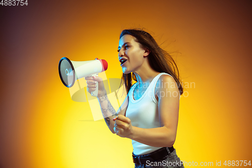 Image of Portrait of young caucasian woman isolated on gradient yellow studio background