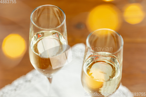 Image of Glasses of sparkling champagne, close up. Warm colored. Celebration event, holidays, drinks concept
