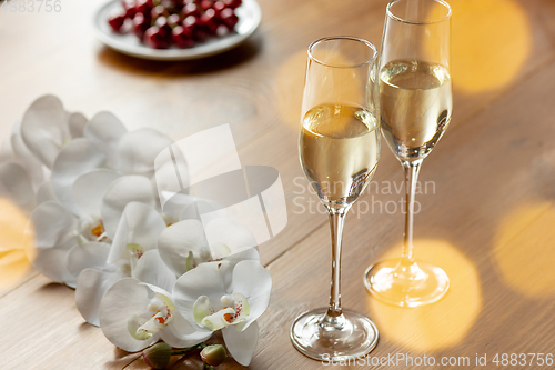 Image of Glasses of sparkling champagne, close up. Warm colored. Celebration event, holidays, drinks concept