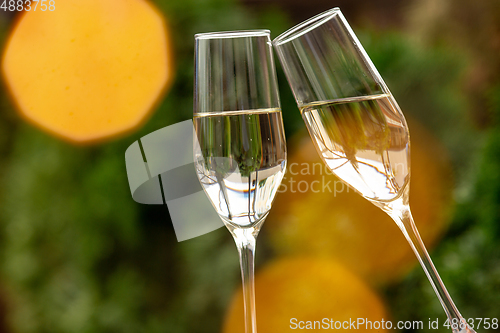 Image of Glasses of sparkling champagne, close up. Warm colored. Celebration event, holidays, drinks concept