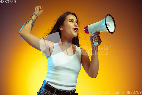 Image of Portrait of young caucasian woman isolated on gradient yellow studio background