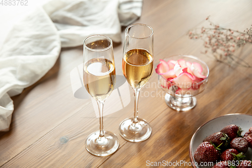 Image of Glasses of sparkling champagne, close up. Warm colored. Celebration event, holidays, drinks concept