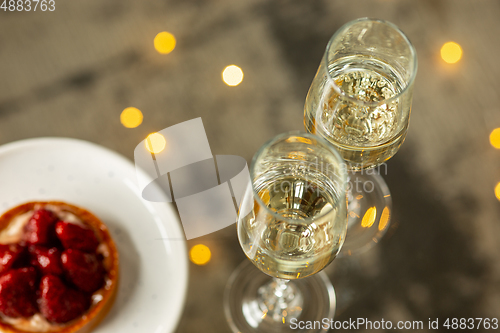 Image of Glasses of sparkling champagne, close up. Warm colored. Celebration event, holidays, drinks concept