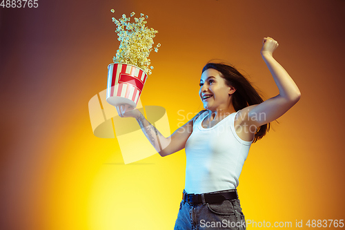 Image of Portrait of young caucasian woman isolated on gradient yellow studio background