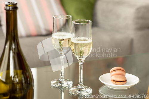 Image of Glasses of sparkling champagne, close up. Warm colored. Celebration event, holidays, drinks concept