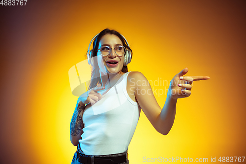 Image of Portrait of young caucasian woman isolated on gradient yellow studio background