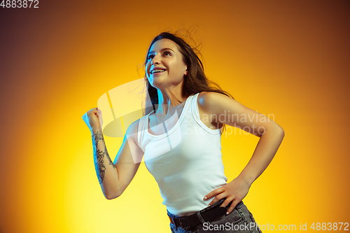 Image of Portrait of young caucasian woman isolated on gradient yellow studio background