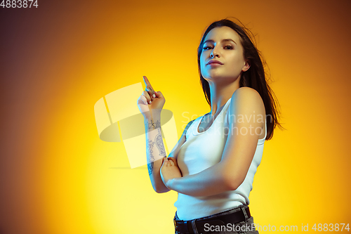 Image of Portrait of young caucasian woman isolated on gradient yellow studio background