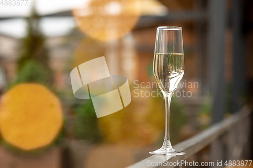 Image of Glass of sparkling champagne, close up. Warm colored. Celebration event, holidays, drinks concept