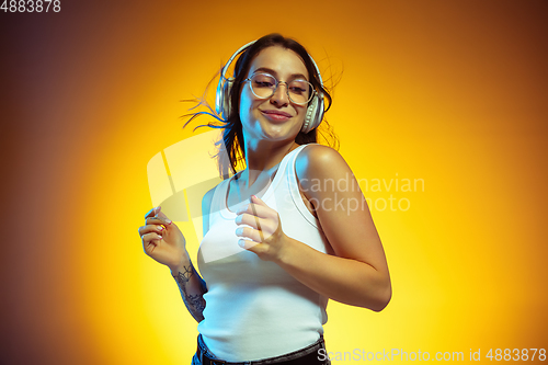 Image of Portrait of young caucasian woman isolated on gradient yellow studio background