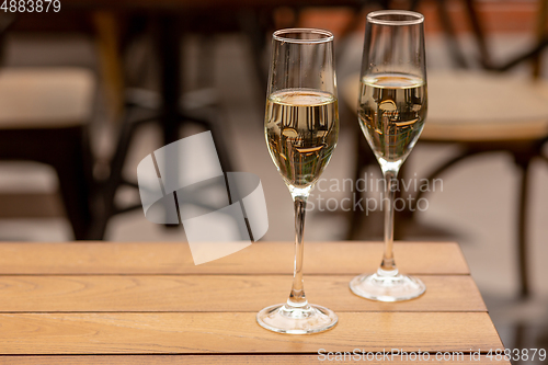 Image of Glasses of sparkling champagne, close up. Warm colored. Celebration event, holidays, drinks concept