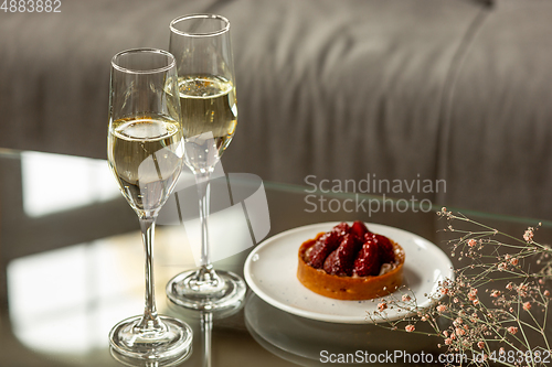 Image of Glasses of sparkling champagne, close up. Warm colored. Celebration event, holidays, drinks concept