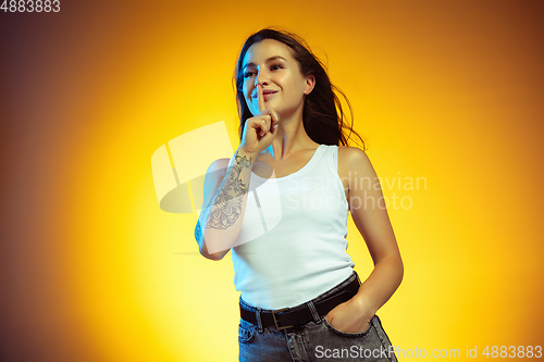 Image of Portrait of young caucasian woman isolated on gradient yellow studio background