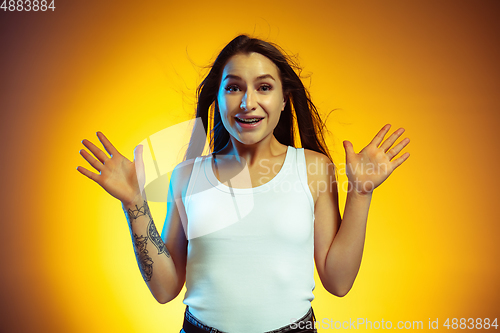 Image of Portrait of young caucasian woman isolated on gradient yellow studio background