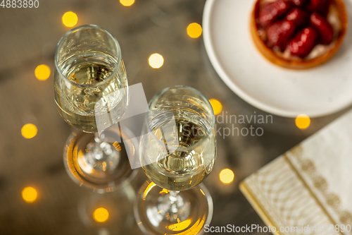 Image of Glasses of sparkling champagne, close up. Warm colored. Celebration event, holidays, drinks concept