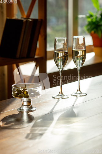 Image of Glasses of sparkling champagne, close up. Warm colored. Celebration event, holidays, drinks concept