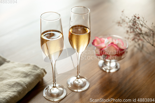 Image of Glasses of sparkling champagne, close up. Warm colored. Celebration event, holidays, drinks concept