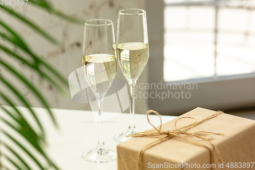 Image of Glasses of sparkling champagne, close up. Warm colored. Celebration event, holidays, drinks concept