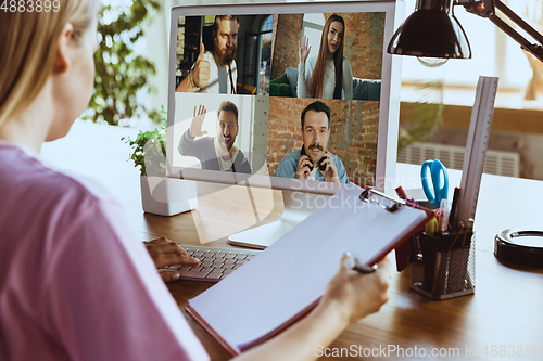 Image of Remote meeting. Woman working from home during coronavirus or COVID-19 quarantine, remote office concept.