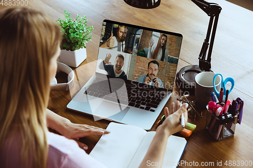 Image of Remote meeting. Woman working from home during coronavirus or COVID-19 quarantine, remote office concept.