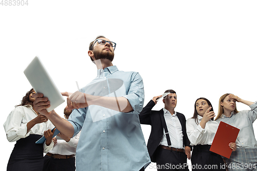 Image of Nervous tensioned investors analyzing crisis stock market with charts on screen of their gadgets