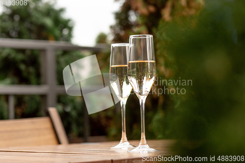 Image of Glasses of sparkling champagne, close up. Warm colored. Celebration event, holidays, drinks concept