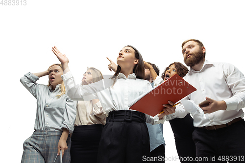 Image of Nervous tensioned investors analyzing crisis stock market with charts on screen of their gadgets