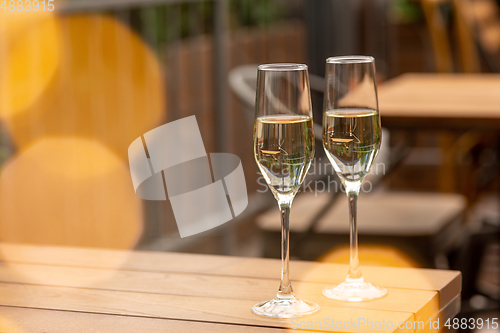 Image of Glasses of sparkling champagne, close up. Warm colored. Celebration event, holidays, drinks concept