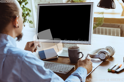 Image of Man working from home during coronavirus or COVID-19 quarantine, remote office concept.