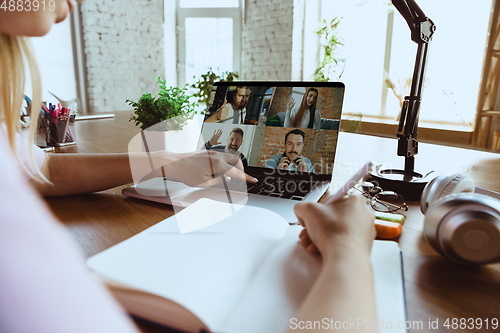 Image of Remote meeting. Woman working from home during coronavirus or COVID-19 quarantine, remote office concept.