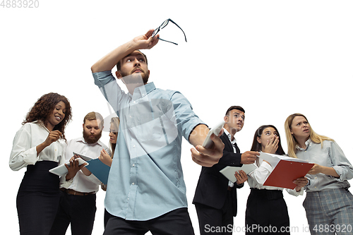 Image of Nervous tensioned investors analyzing crisis stock market with charts on screen of their gadgets