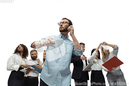 Image of Nervous tensioned investors analyzing crisis stock market with charts on screen of their gadgets