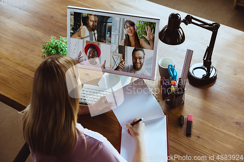 Image of Remote meeting. Woman working from home during coronavirus or COVID-19 quarantine, remote office concept.