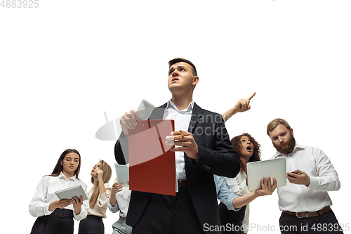 Image of Nervous tensioned investors analyzing crisis stock market with charts on screen of their gadgets