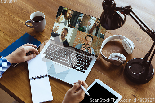 Image of Remote meeting. Man working from home during coronavirus or COVID-19 quarantine, remote office concept.