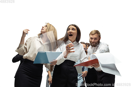 Image of Nervous tensioned investors analyzing crisis stock market with charts on screen of their gadgets