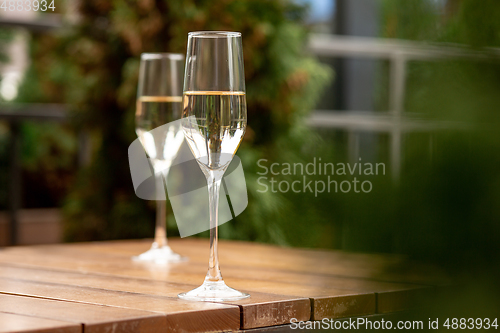 Image of Glasses of sparkling champagne, close up. Warm colored. Celebration event, holidays, drinks concept