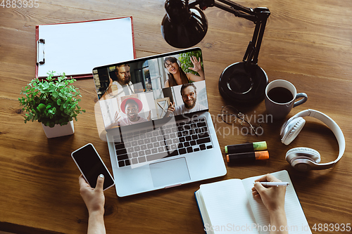 Image of Remote meeting. Woman working from home during coronavirus or COVID-19 quarantine, remote office concept.