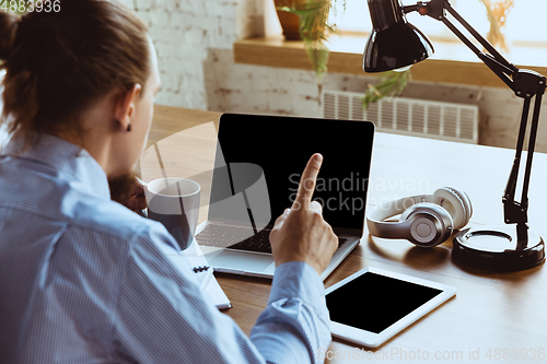 Image of Man working from home during coronavirus or COVID-19 quarantine, remote office concept.