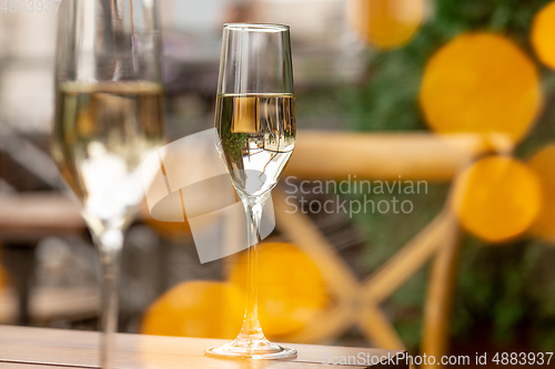 Image of Glasses of sparkling champagne, close up. Warm colored. Celebration event, holidays, drinks concept