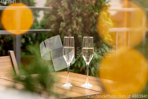 Image of Glasses of sparkling champagne, close up. Warm colored. Celebration event, holidays, drinks concept