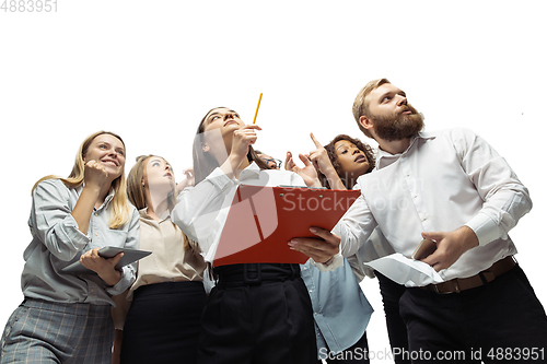 Image of Nervous tensioned investors analyzing crisis stock market with charts on screen of their gadgets