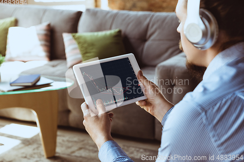 Image of Man working from home during coronavirus or COVID-19 quarantine, remote office concept.