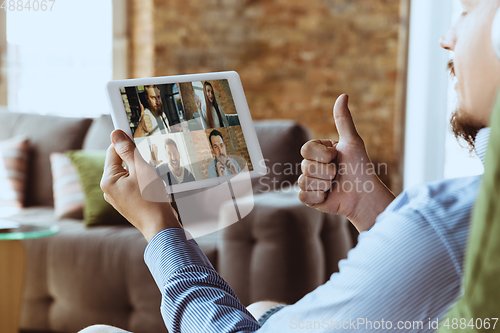 Image of Remote meeting. Man working from home during coronavirus or COVID-19 quarantine, remote office concept.