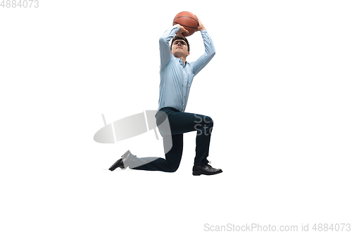 Image of Man in office clothes playing basketball on white background. Unusual look for businessman in motion, action. Sport, healthy lifestyle.