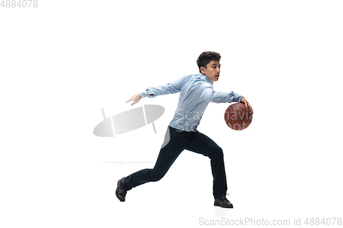 Image of Man in office clothes playing basketball on white background. Unusual look for businessman in motion, action. Sport, healthy lifestyle.