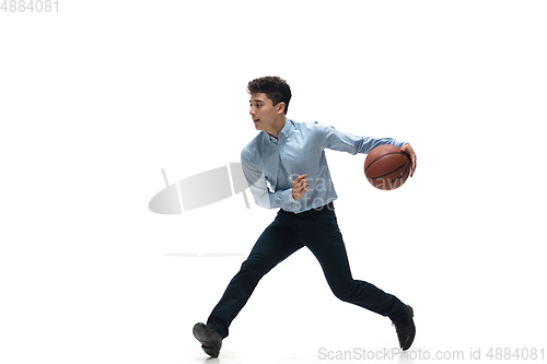 Image of Man in office clothes playing basketball on white background. Unusual look for businessman in motion, action. Sport, healthy lifestyle.