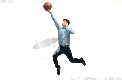 Image of Man in office clothes playing basketball on white background. Unusual look for businessman in motion, action. Sport, healthy lifestyle.