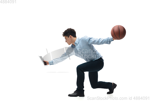 Image of Man in office clothes playing basketball on white background. Unusual look for businessman in motion, action. Sport, healthy lifestyle.