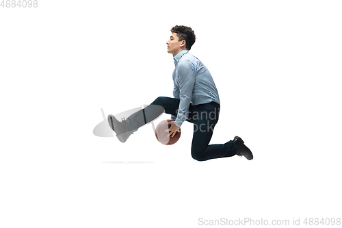 Image of Man in office clothes playing basketball on white background. Unusual look for businessman in motion, action. Sport, healthy lifestyle.